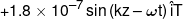  + 1.8 \times {10^{ - 7}}\sin \left( {kz - \omega t} \right)\hat iT
